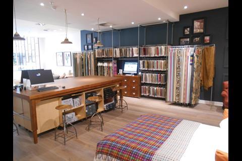 Sofa Workshop breaks up the store with a desk where shoppers can look at fabric samples